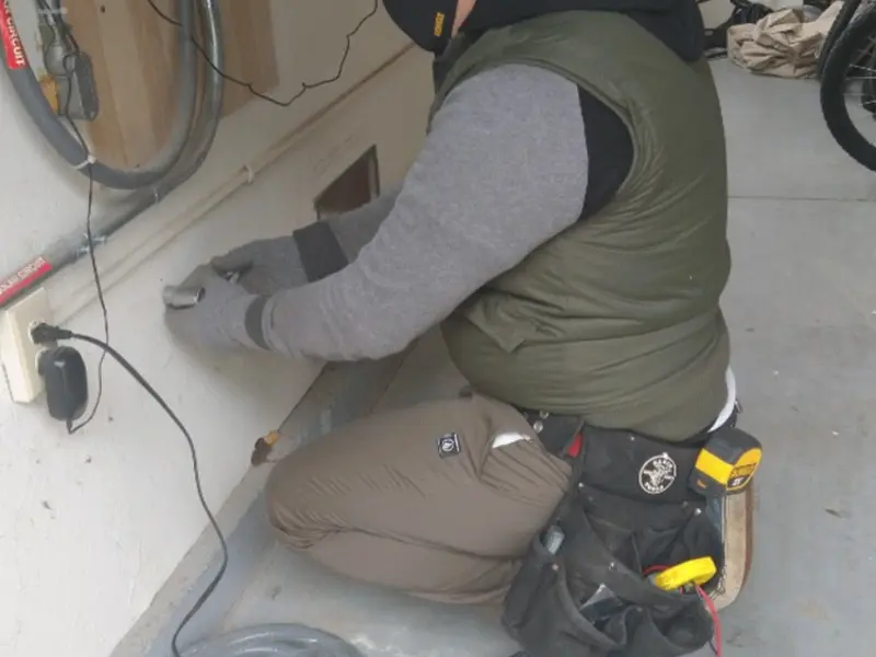 Electrician performing outlet wiring in a Maurice River garage
